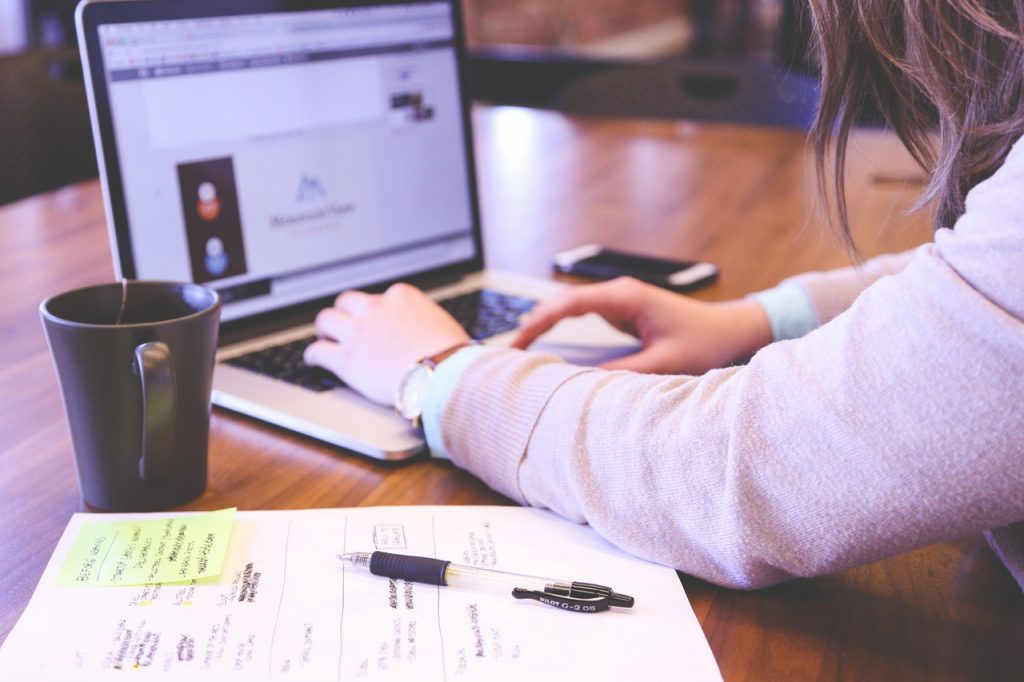 Woman in front of laptop Central Credit Register